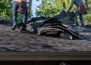 Gutters and downspouts directing rainwater away from a home during a spring storm.