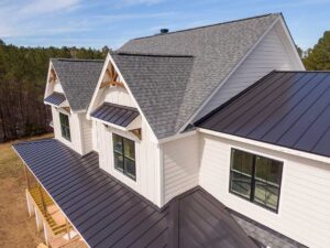 Homeowner inspecting roof shingles and cleared gutters beside a house before heavy rain.
