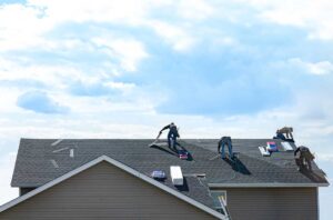 Evenly spread attic insulation around roof framing with visible air-sealing details and ventilation baffles.